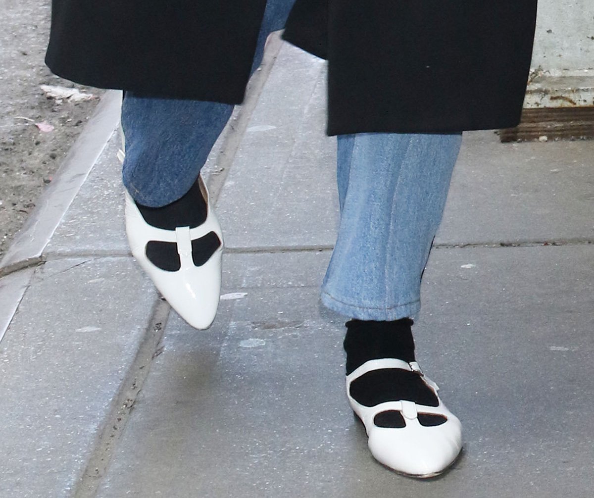 Katie Holmes is bringing back the 2015 ballerina flats with socks trend by pairing her white A.P.C. ballet flats with black ankle socks