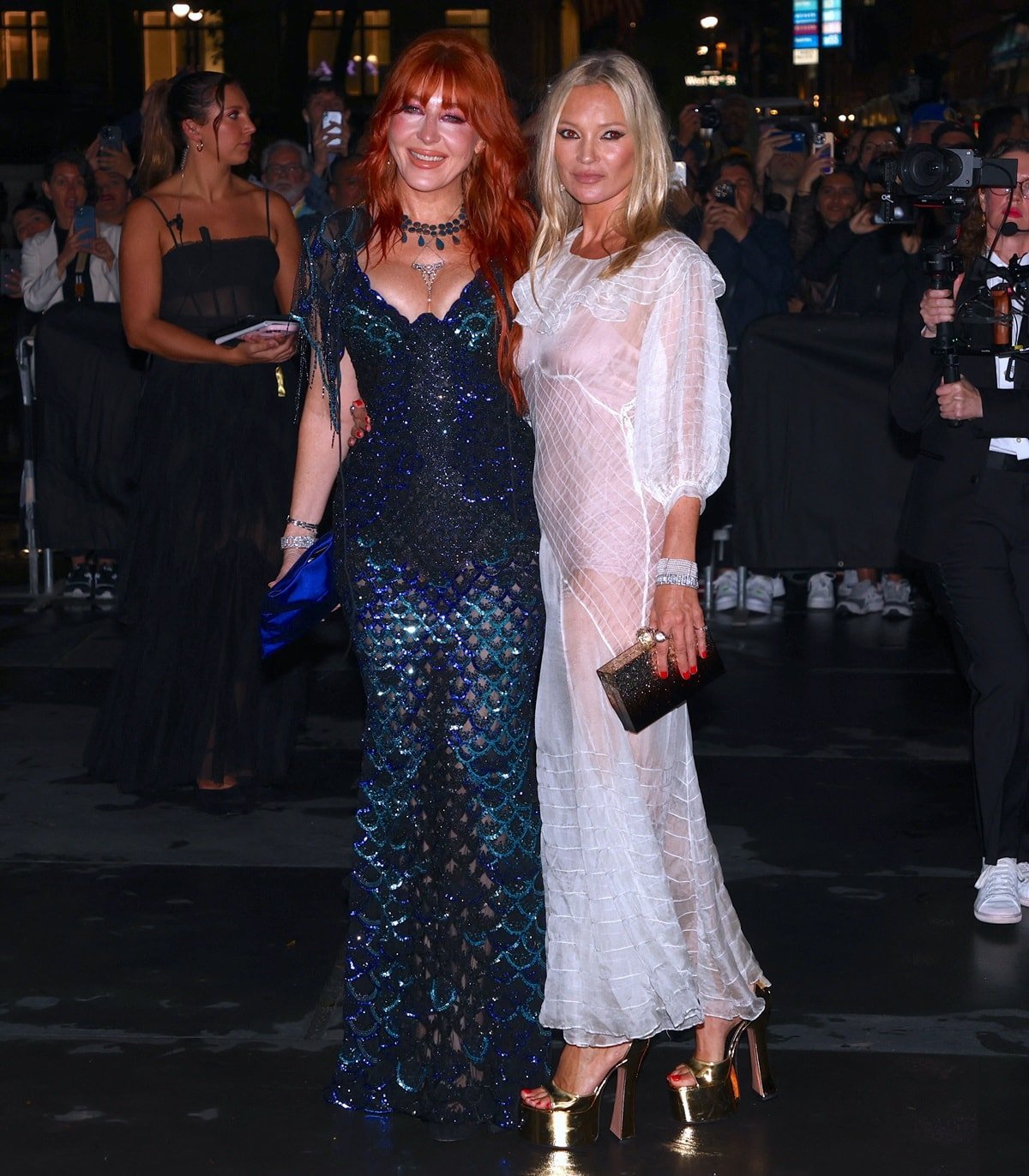 Charlotte Tilbury stuns in a shimmering mermaid-inspired gown, while Kate Moss commands attention in a sheer white dress paired with bold gold platform heels at the Clooney Foundation For Justice’s “The Albies” on September 28, 2023, in New York City