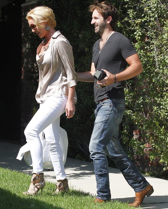 A stylish Katherine Heigl steps out with Josh Kelley, pairing crisp white skinny jeans with a flowy nude blouse and statement-embellished peep-toe booties