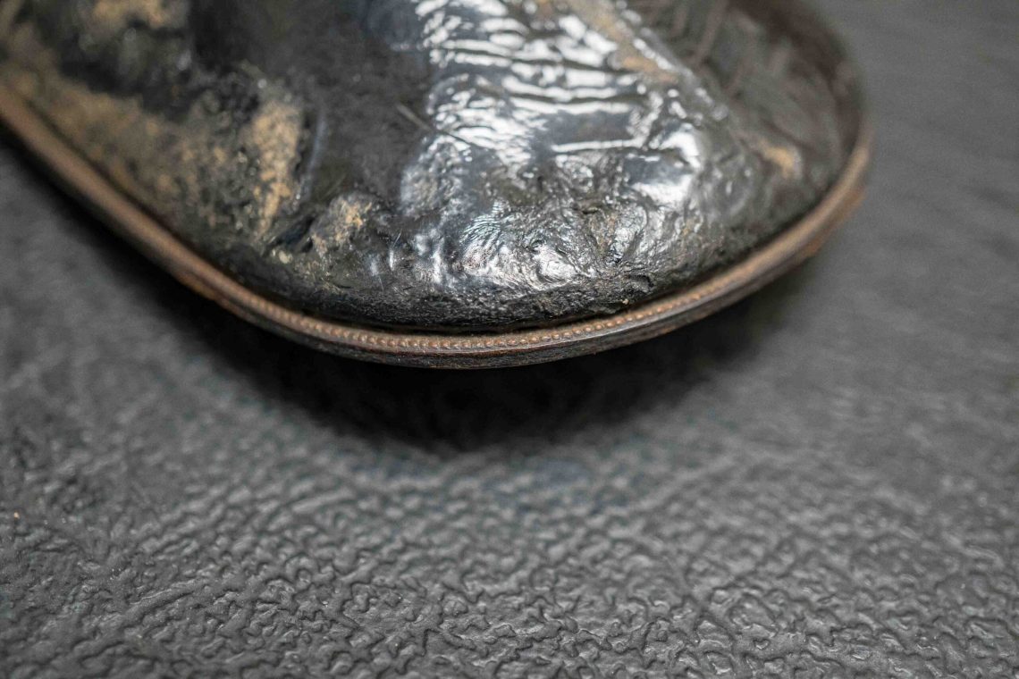The patent leather isn't in the best condition.
